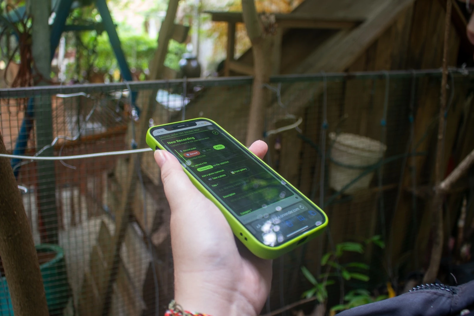 A participant uses the Saigon_Miền Tây Sound Map during a sound walk.