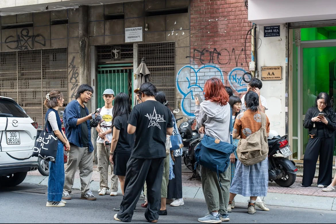 Participants gathering with headphones and phones outside Rare Sea Gallery for Urban Listening.